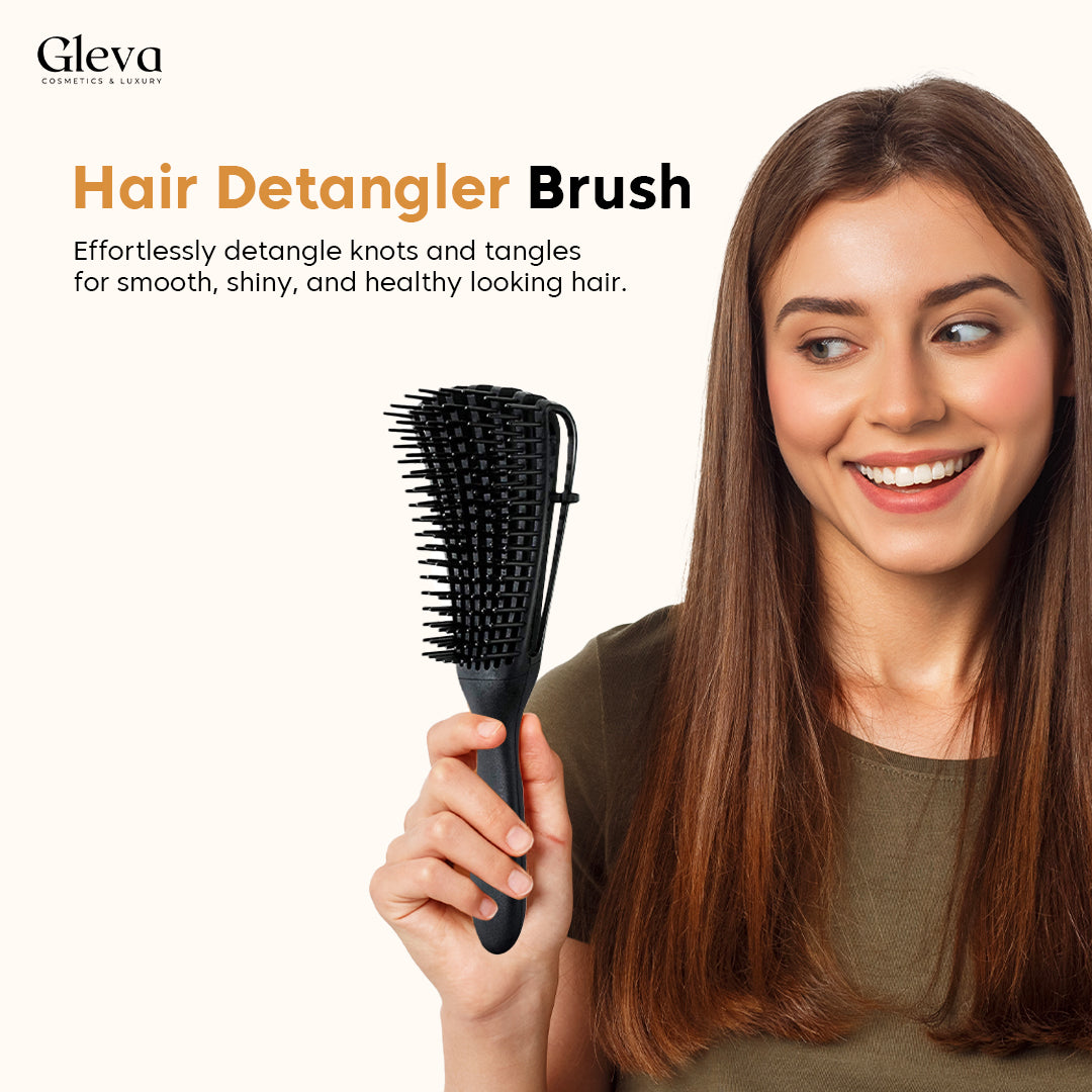 A woman holding the detangling brush