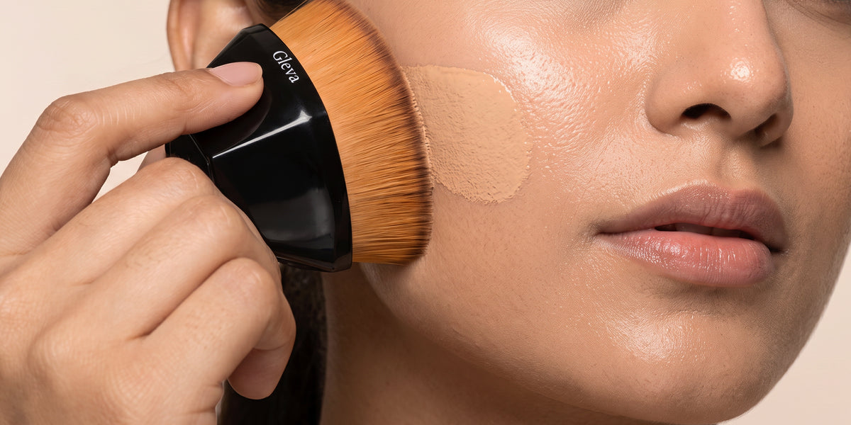 A woman sweeping a Gleva powder brush over her cheek