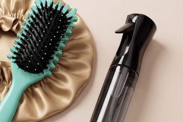 Curl Defining Hair Brush on a champagne satin Night Wrap, beside the black Mist Water Spray