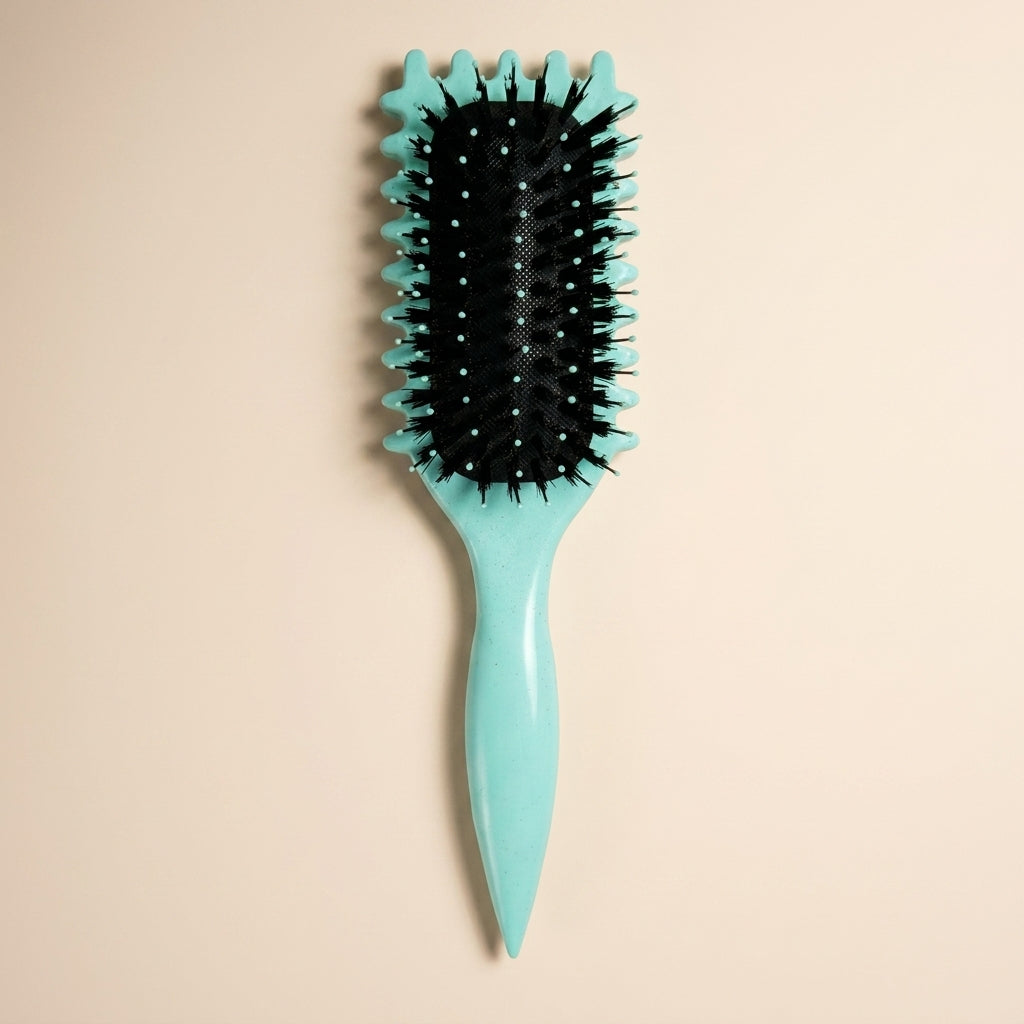 The Curl Defining Hair Brush on a cream background