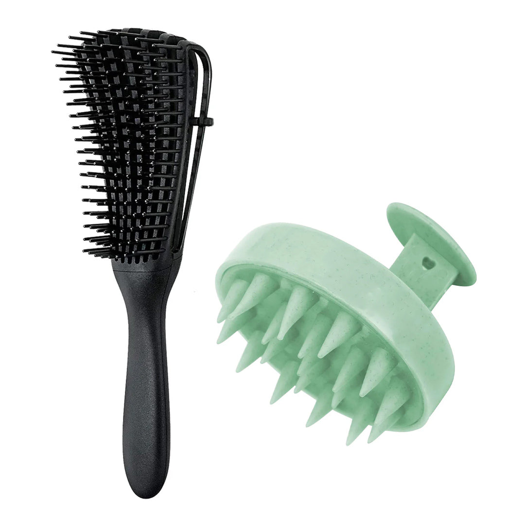 The black detangling brush beside a round mint-green scalp scrubber