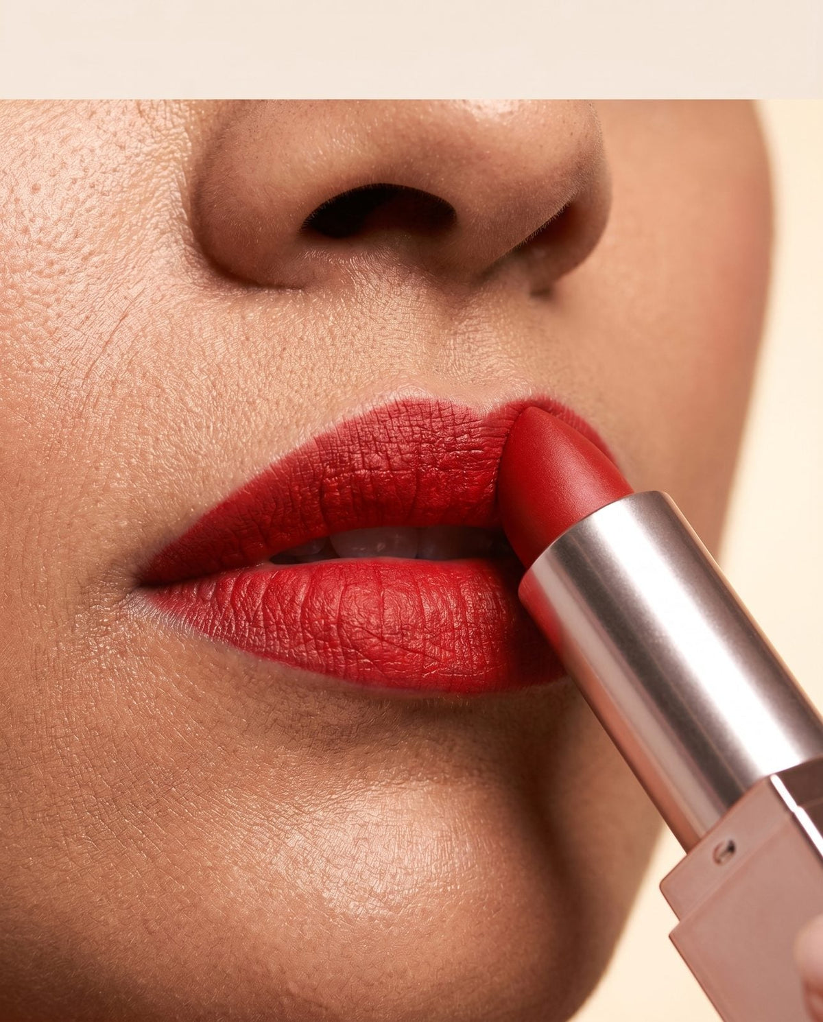 Applying the Creamy Matte bullet to the lips