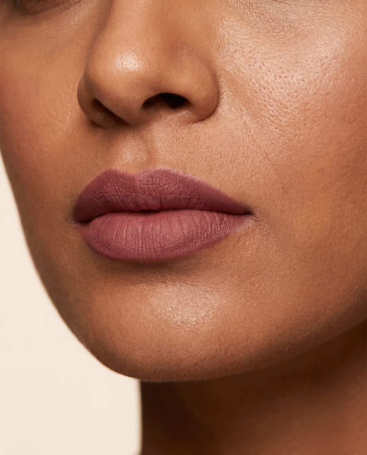Close-up of soft matte rosewood lips on deep skin