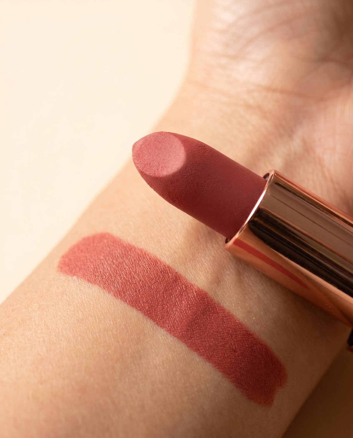 A Creamy Matte bullet and its swatch on an inner wrist