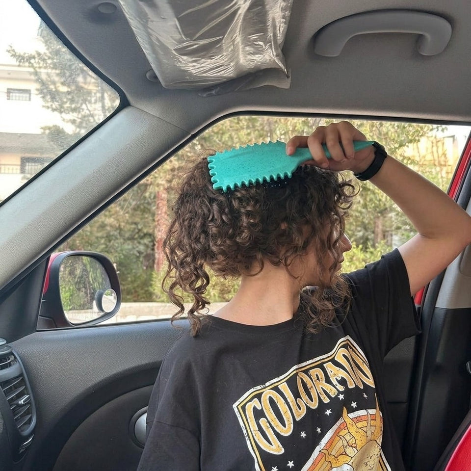 Brushing curls in the car with the aqua curl brush